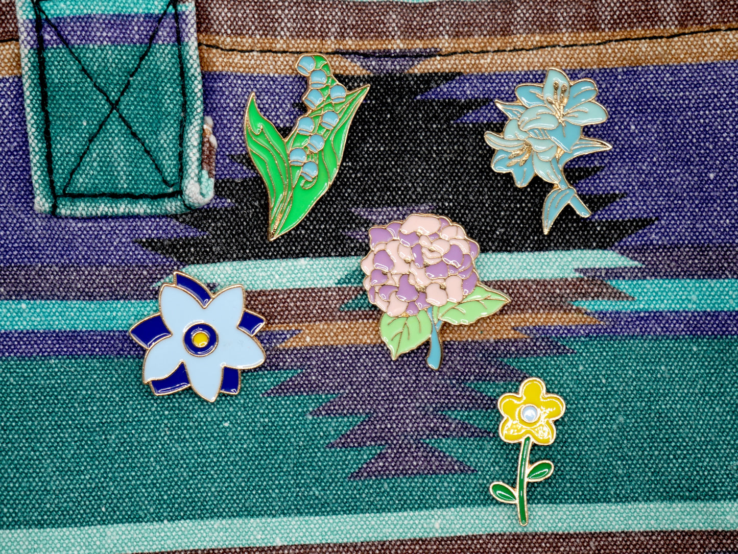 Get in the spring and summer feeling with a randomly chosen set of 3 flower enamel metal pins.