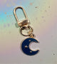These dreamy gold and navy blue moon keychain and bag charms are great for gifts or building a keychain stack. Complete with inlay gold-finish stars, they are made of sturdy metal.&nbsp;